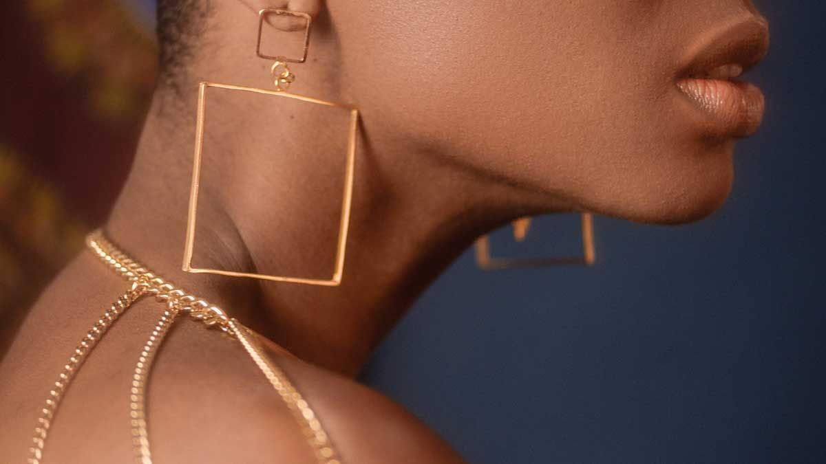 Photo Credit: Wherbson Rodrigues. geometric earrings and chain harness on African American model